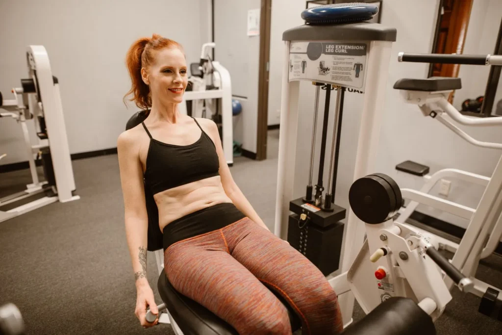 Donna adulta durante un esercizio per le gambe in palestra